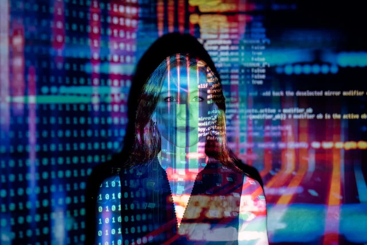 An image of a woman in front of a computer screen.